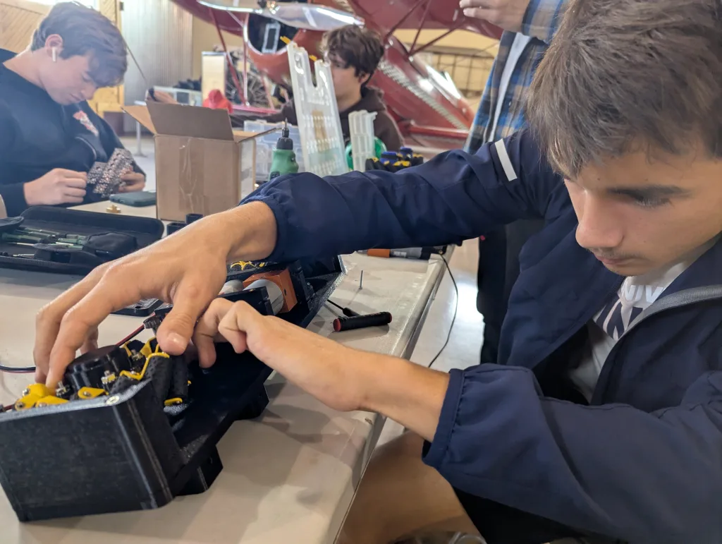 Nick inserts spacers into drive base.